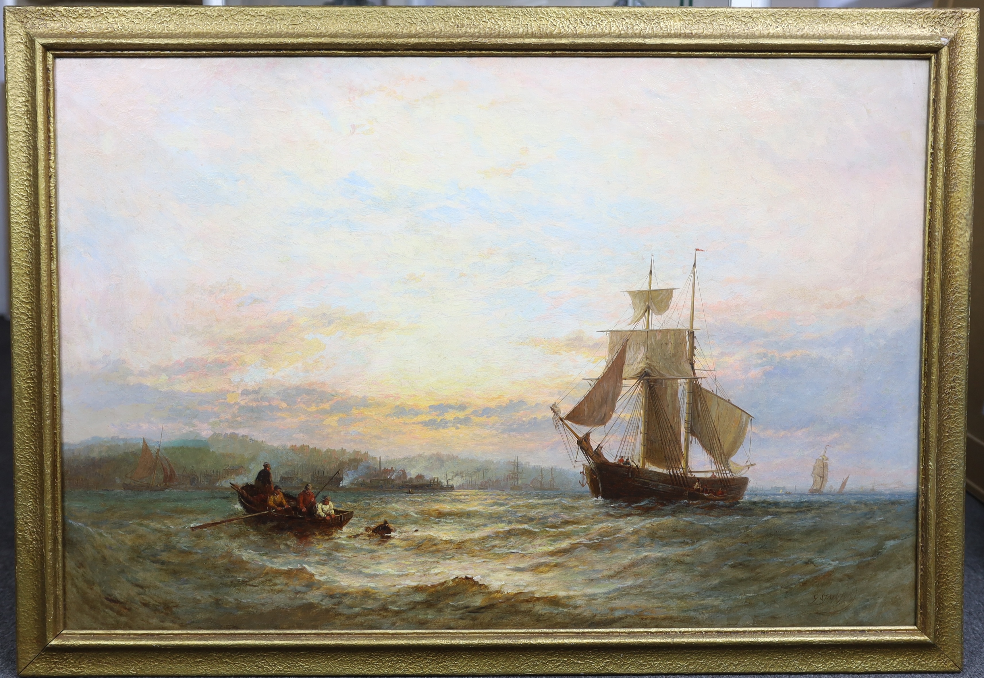 George Stainton (British, fl. 1860-1890), Shipping in a calm sea at dawn, oil on canvas, 60 x 90cm